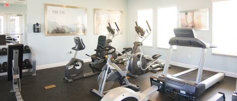 A gym with treadmills, stationary bikes, and weight machines.