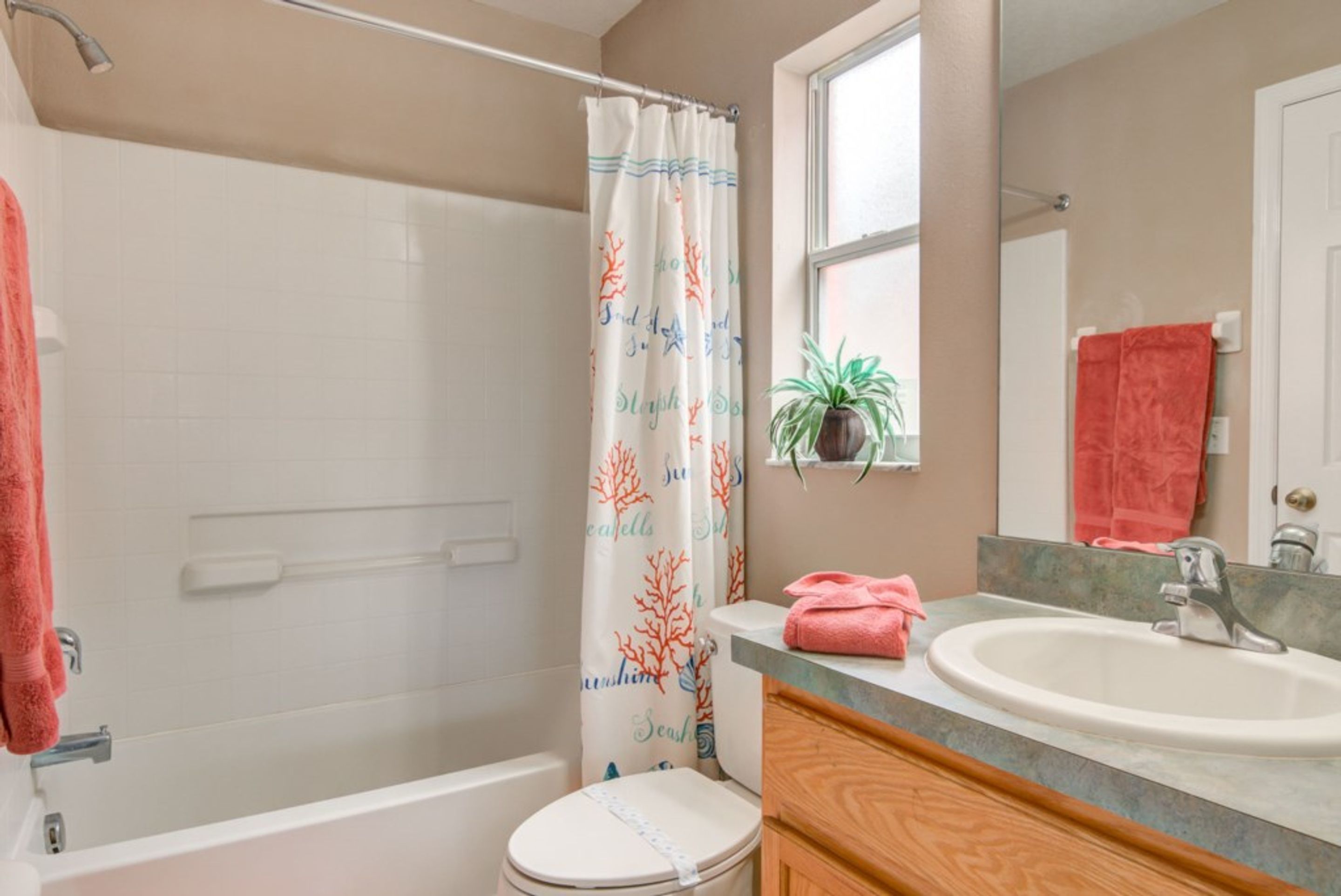A bathroom with a bathtub, toilet, and sink.