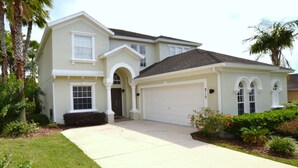 A two-story house with a front garage, a covered entryway, and a well-maintained lawn. - Calabay Parc 215 (Davenport)