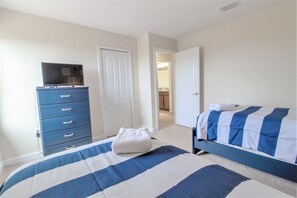A bedroom with a bed, a dresser, and a television on top. - Champions Gate 9039 B (Davenport)