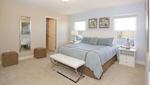 A bedroom with a bed, bench, bedside tables, and artwork on the walls. - Solterra 4405 (Davenport)