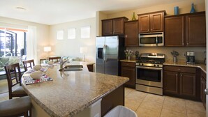 A modern kitchen with granite countertops, stainless steel appliances, and wooden cabinets. - Solterra 4405 (Davenport)
