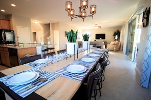 Enjoy meals in this dining area with a long table and comfortable seating.