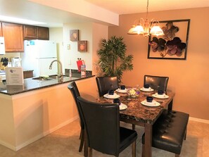 Enjoy meals in the kitchen with a central island, oven, and dining table for four.