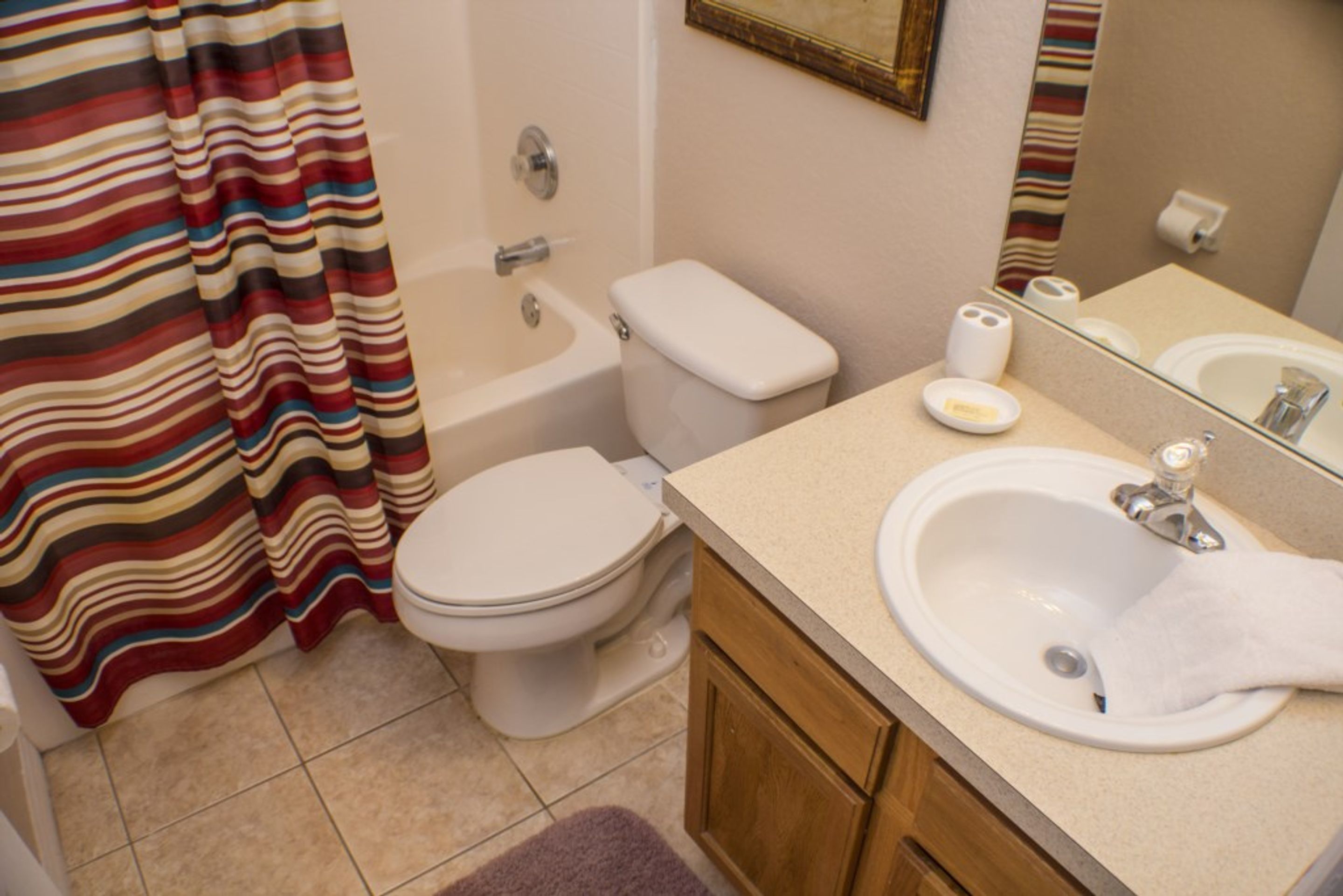 A bathroom with a bathtub, toilet, and sink.