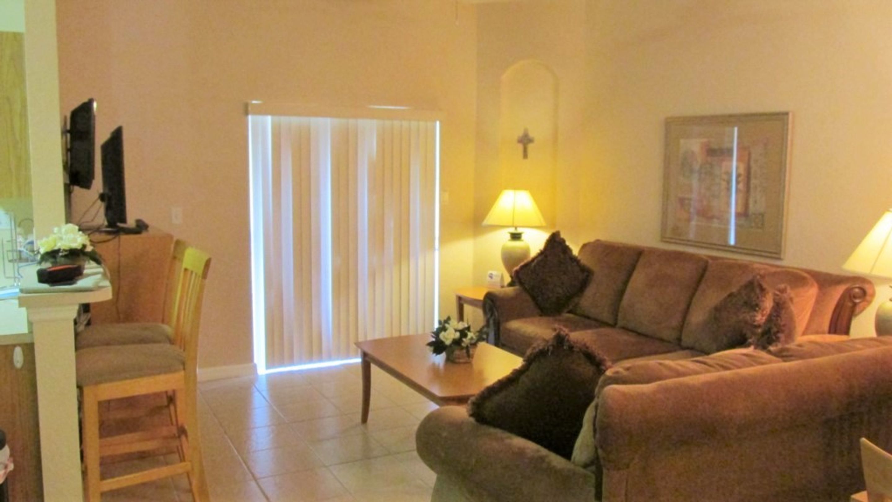 A living room with a sofa, a coffee table, and a TV on a stand.