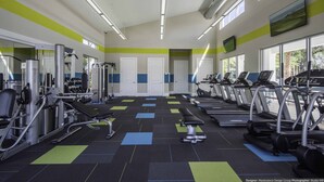 A gym with exercise equipment, treadmills, and weight machines.