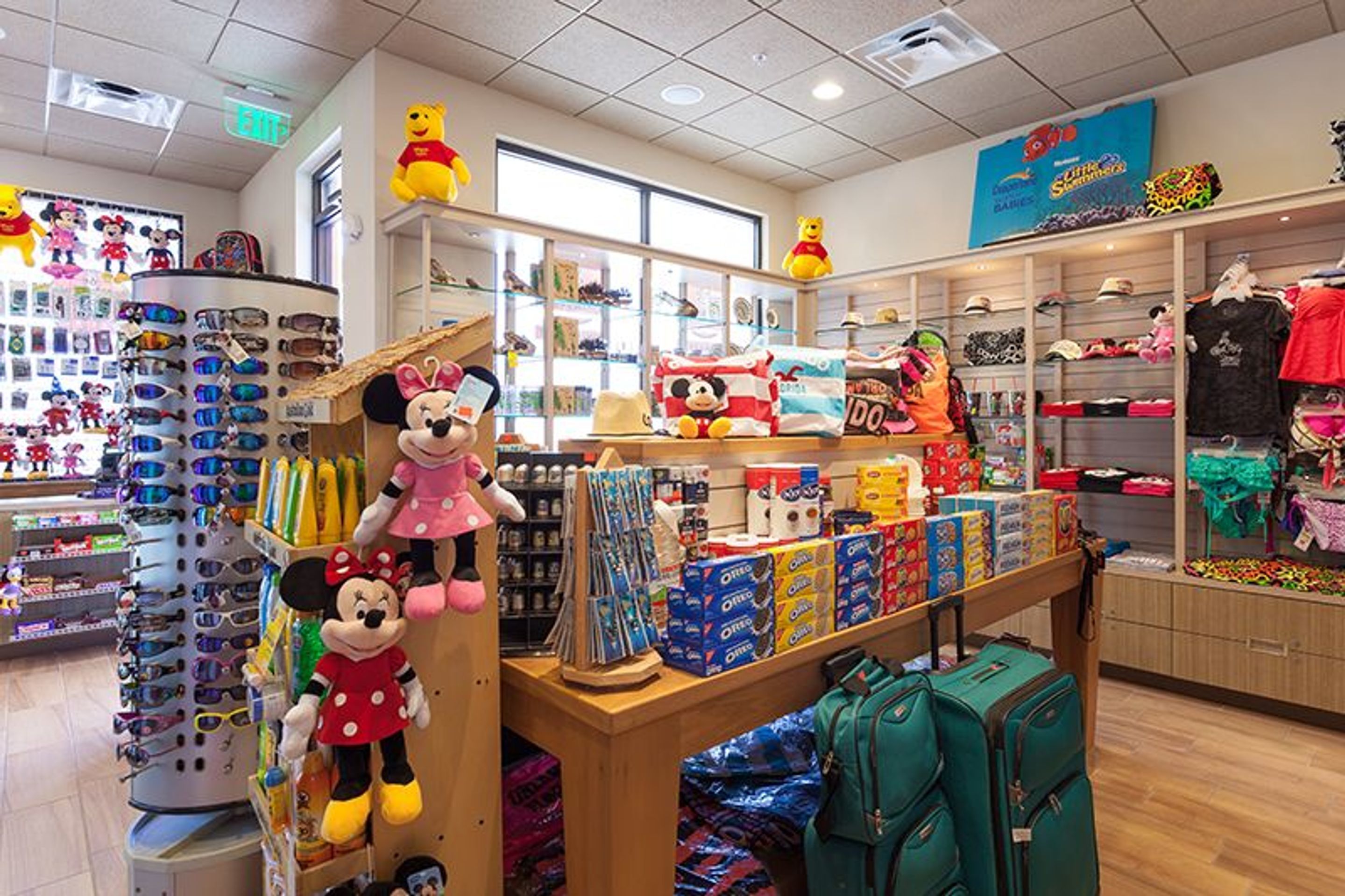A children's store with shelves of toys, Minnie Mouse and Daisy dolls, and various boxed items.
