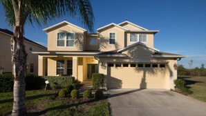 A two-story house with a garage, a front porch, and a well-maintained lawn. - The Shire at West Haven 1012 (Davenport)