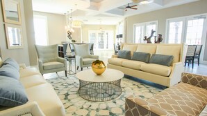 A spacious living room with a beige sofa, armchairs, a coffee table with a decorative bowl, and a patterned rug. - Solterra 4670 (Davenport)