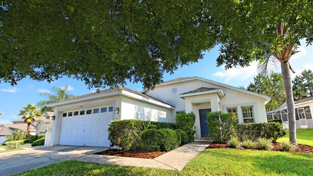 A single-story house with a garage, a front porch, and a well-maintained lawn. - Highlands Reserve Golf & Country Club 301 (Davenport)