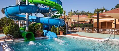 A pool with a multi-level water slide structure.