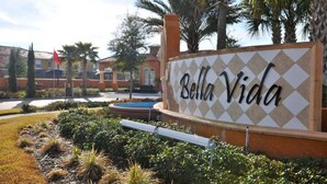A sign for Bella Vida with a diamond-patterned background and the name in cursive. - Bella Vida 851 (Kissimmee)