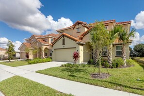 A residential neighborhood with houses featuring red-tiled roofs and beige exteriors. - Solterra 5240 (Davenport)