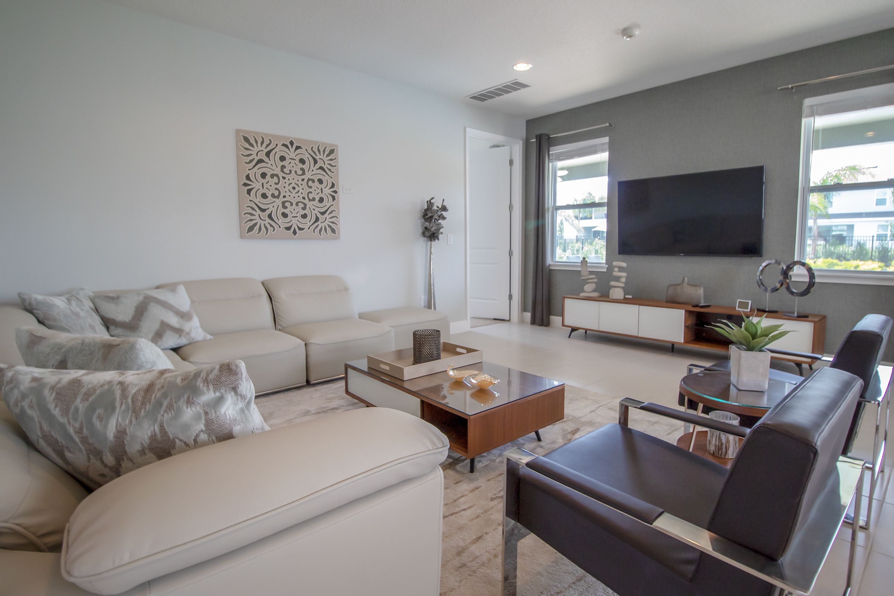 A modern living room with a sofa, coffee table, and a TV.