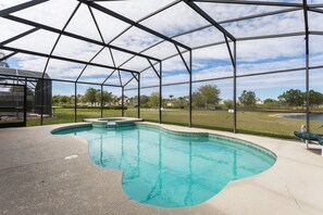 An indoor swimming pool with a clear view of the surrounding landscape.