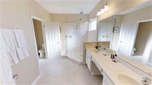 A modern bathroom with a walk-in shower, a large mirror, and a double sink vanity. - Golden Palms Vacation Resort 4439 (Kissimmee)