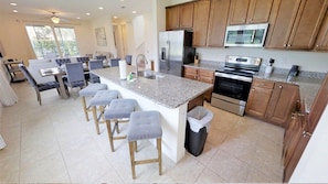 Enjoy cooking in this well-equipped kitchen with a central island and stainless steel appliances.