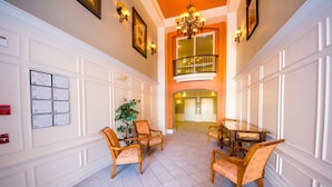 A spacious lobby with a high ceiling, a balcony, and a dining area with wooden furniture. - Vista Cay 4804 B12.403 (Orlando)
