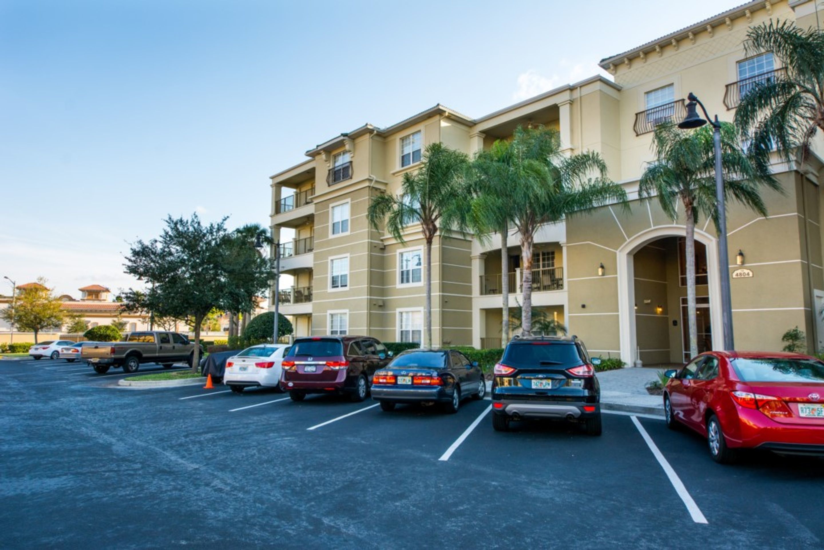 A multi-story parking garage with several cars parked in designated spaces.