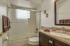 A bathroom with a bathtub, toilet, and sink. - Southern Dunes 2171 (Haines City)