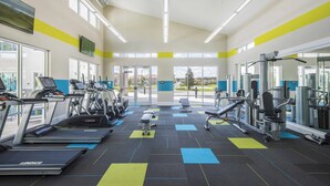 A gym with treadmills, weight machines, and a bench. - Veranda Palms 2505 (Kissimmee)