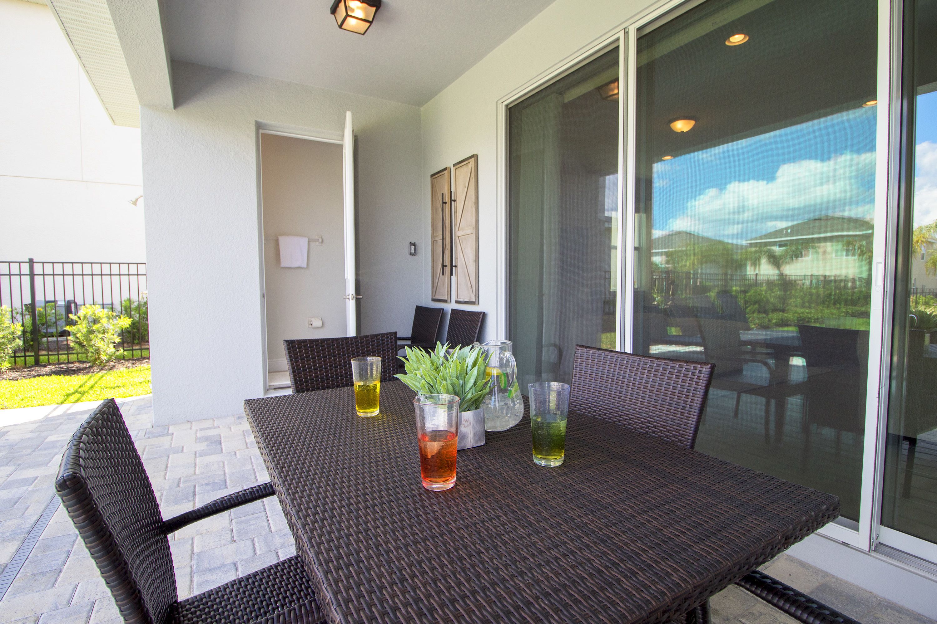 An outdoor patio with a table, chairs, and drinks.