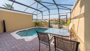 A covered outdoor area with a pool, seating, and a view of the surrounding landscape. - Encantada Resort 3143 (Kissimmee)