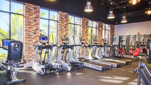 A gym with multiple treadmills, stationary bikes, and weight machines. - Festival Resort 313 (Davenport)