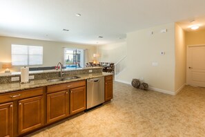 Enjoy cooking in this well-equipped kitchen with a granite countertop, stainless steel appliances, and ample cabinetry.