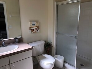 A bathroom with a toilet, sink, and shower. - Terra Verde Resort 4762 (Kissimmee)