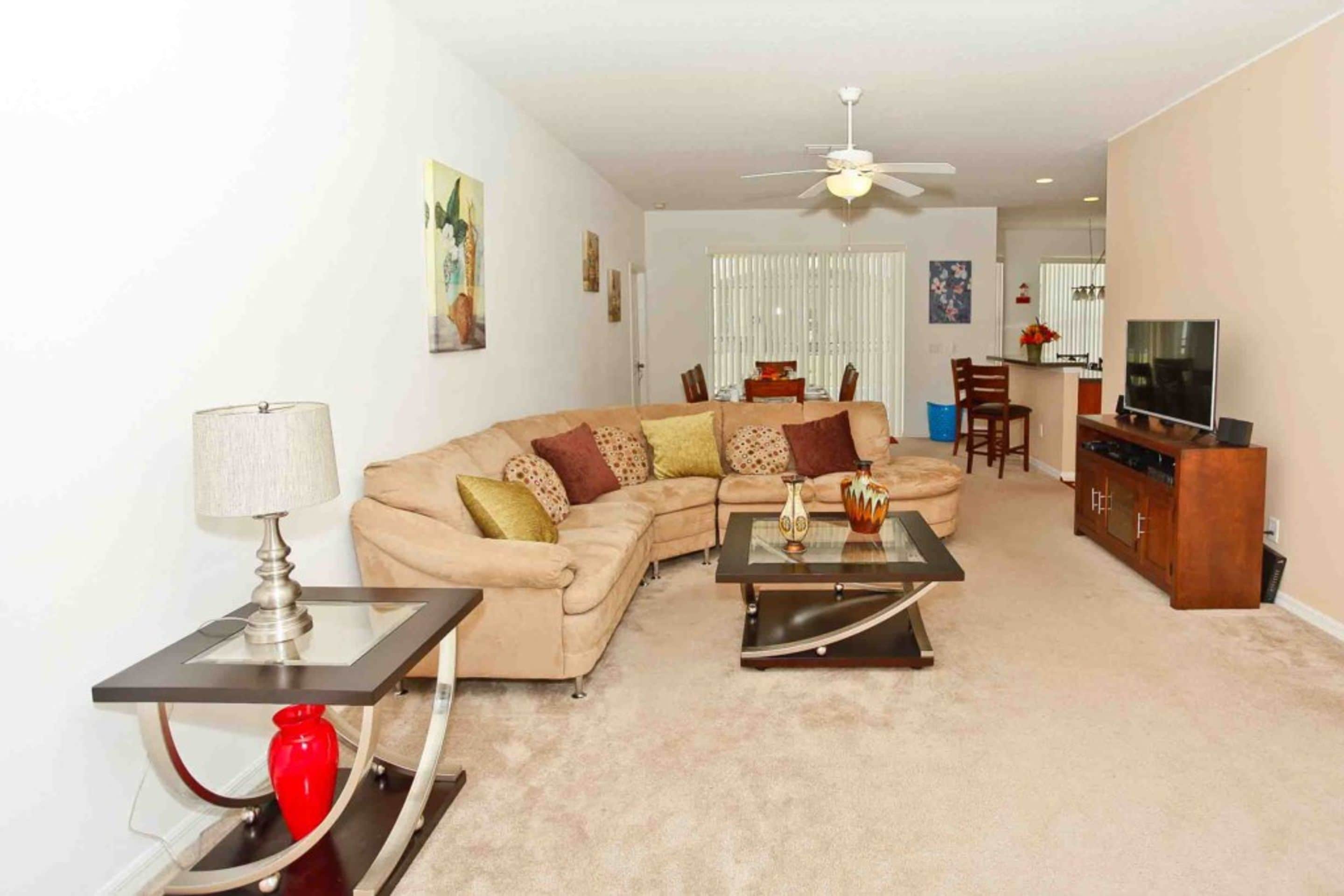 A living room with a sofa, coffee table, and TV stand.
