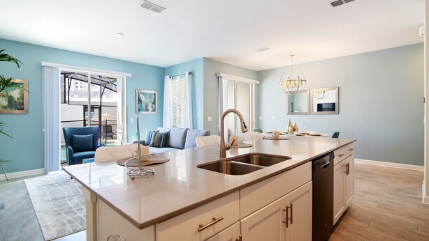 A modern kitchen with a central island, built-in dishwasher, and a large window. - Storey Lake 4953 (Kissimmee)