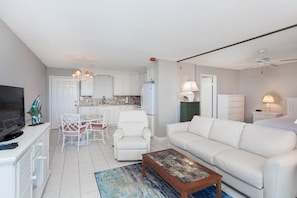 Relax in this stylish living space with a sofa, dining area, and fully equipped kitchen.