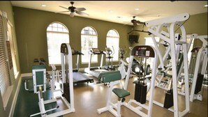 A gym with treadmills, weight machines, and a bench. - Bella Piazza 904 - 527 (Davenport)