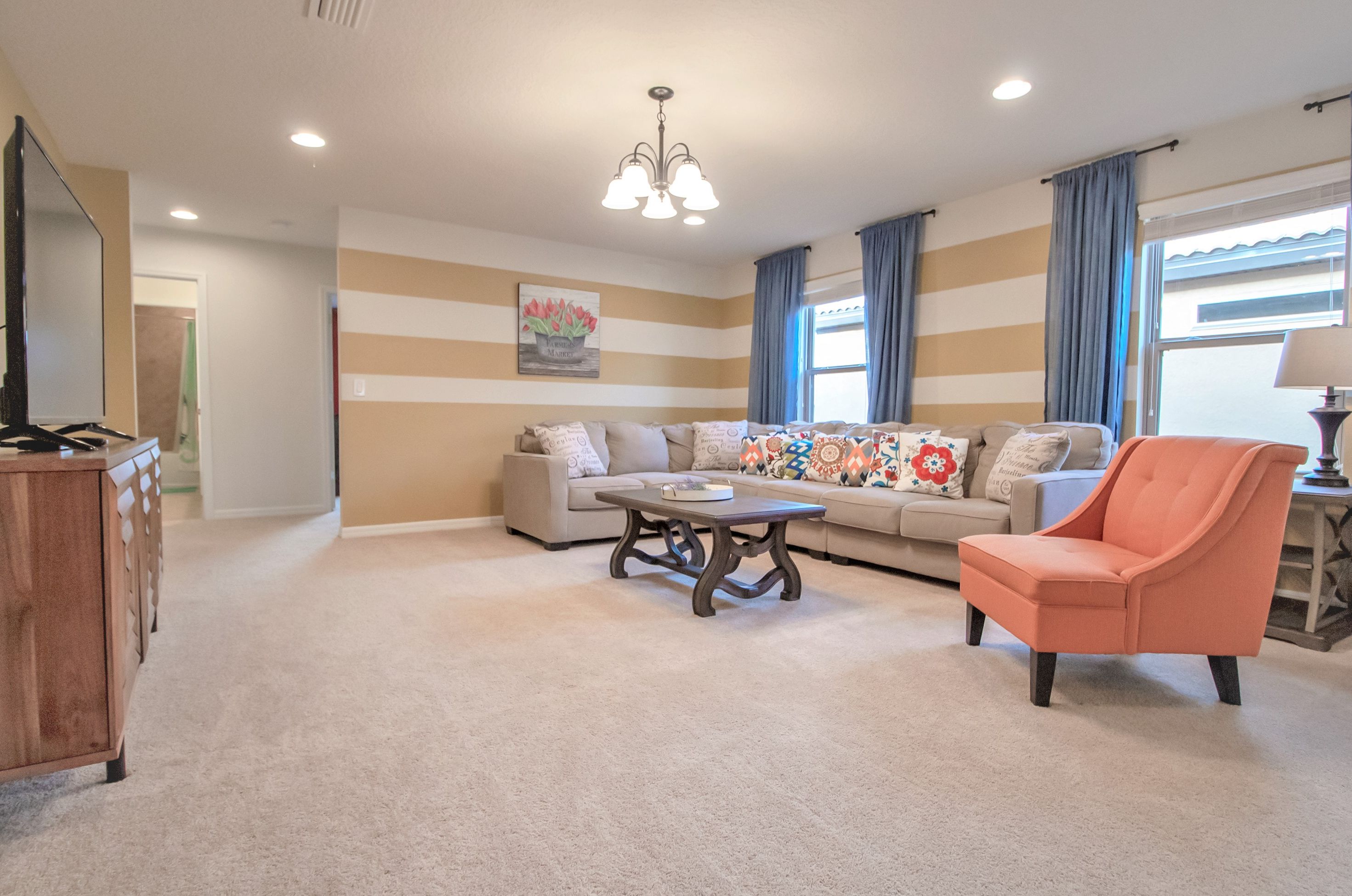 A living room with a sofa, armchair, and coffee table.