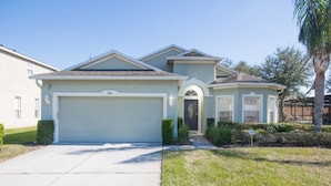 A single-story house with a garage, a front door, and a small porch.