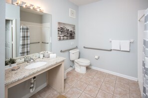 A bathroom with a sink, toilet, and shower area. - Windsor Palms 2300 - 101 (Kissimmee)