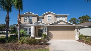 A two-story house with a garage, a front porch, and a well-maintained lawn. - The Shire at West Haven 841 (Davenport)