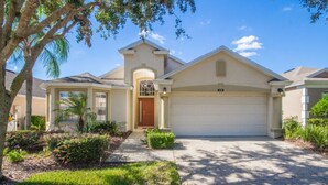 A single-story house with a garage, a front porch, and a well-maintained lawn. - The Hamlet at Westhaven 238 (Davenport)