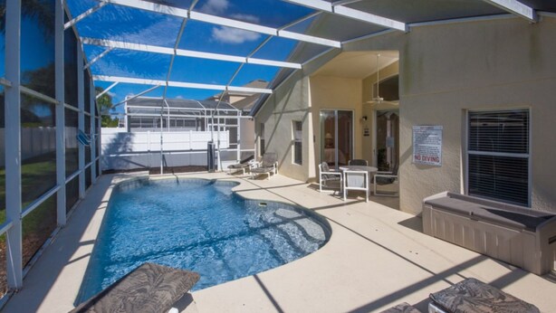 An outdoor swimming pool with a covered area, lounge chairs, and a 'No Diving' sign. - The Hamlet at Westhaven 238 (Davenport)