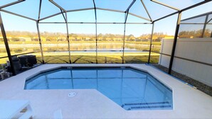 A hot tub with a view of a lake and houses in the background. - Bella Vida 541 A (Kissimmee)