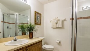 A bathroom with a sink, toilet, and shower. - Marbella 1020 (Davenport)