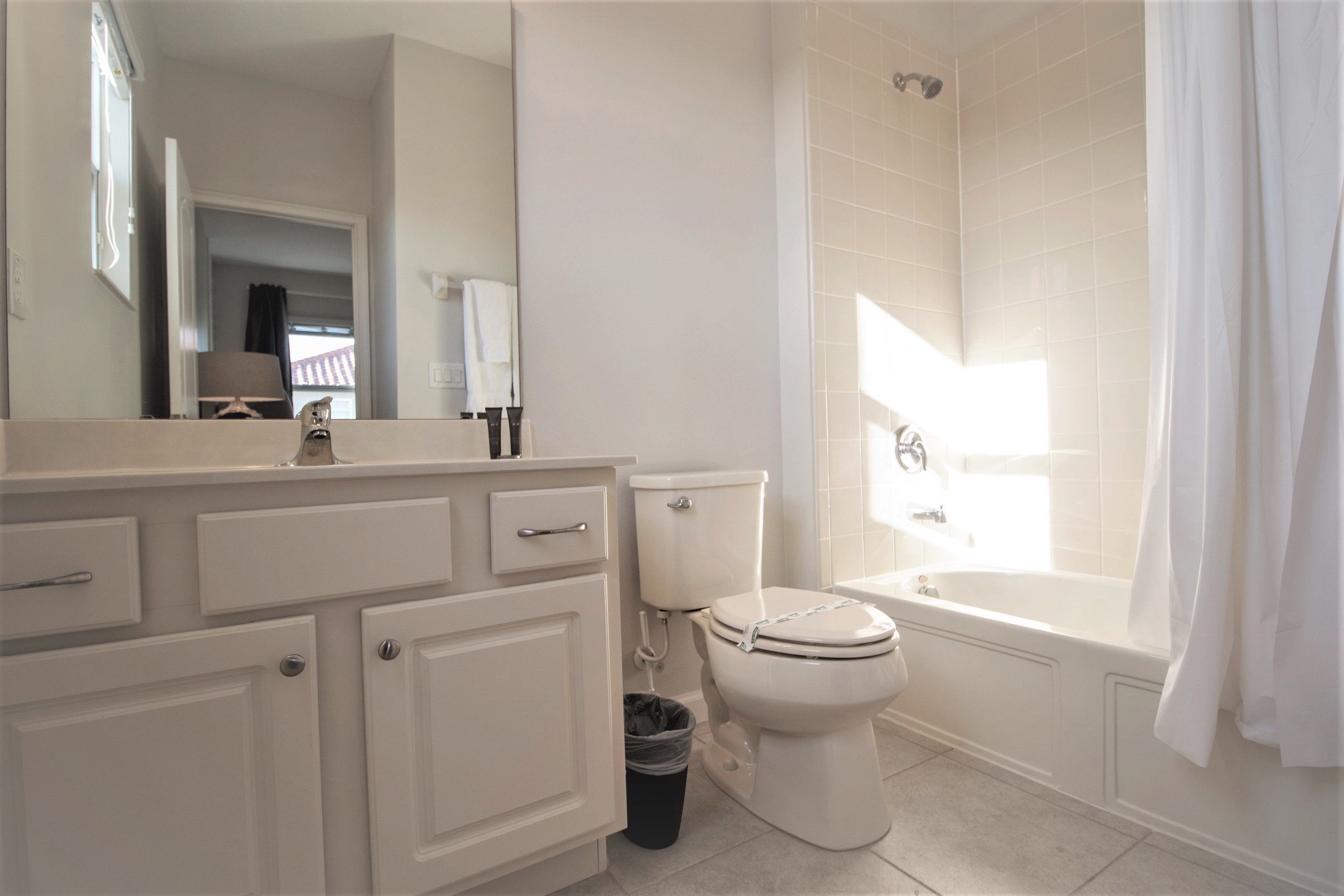 A modern bathroom with a toilet, sink, and bathtub.