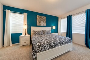 A bedroom with a bed, nightstands, and a painting on the wall. - Sonoma Resort 2682 (Kissimmee)