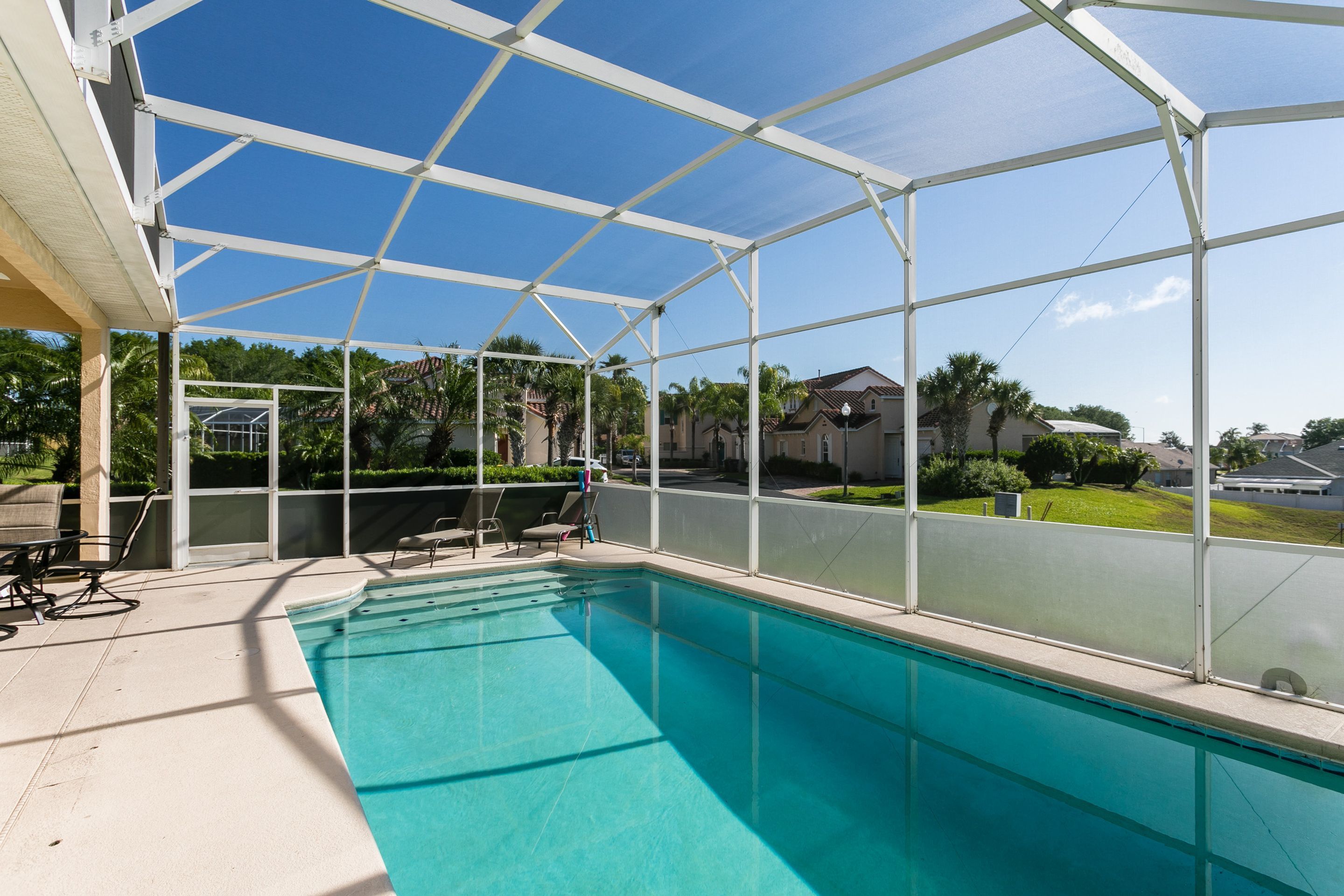 A covered swimming pool with a clear view of the surrounding neighborhood.