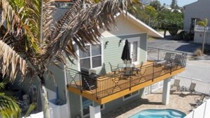 A two-story house with a balcony and a swimming pool. - Anna Maria Island 4102 - 10 (Holmes Beach)