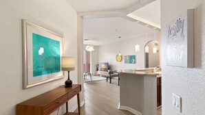 A modern kitchen with a central island, pendant lighting, and a view into the dining area. - Vista Cay 4862 - 202 (Orlando)