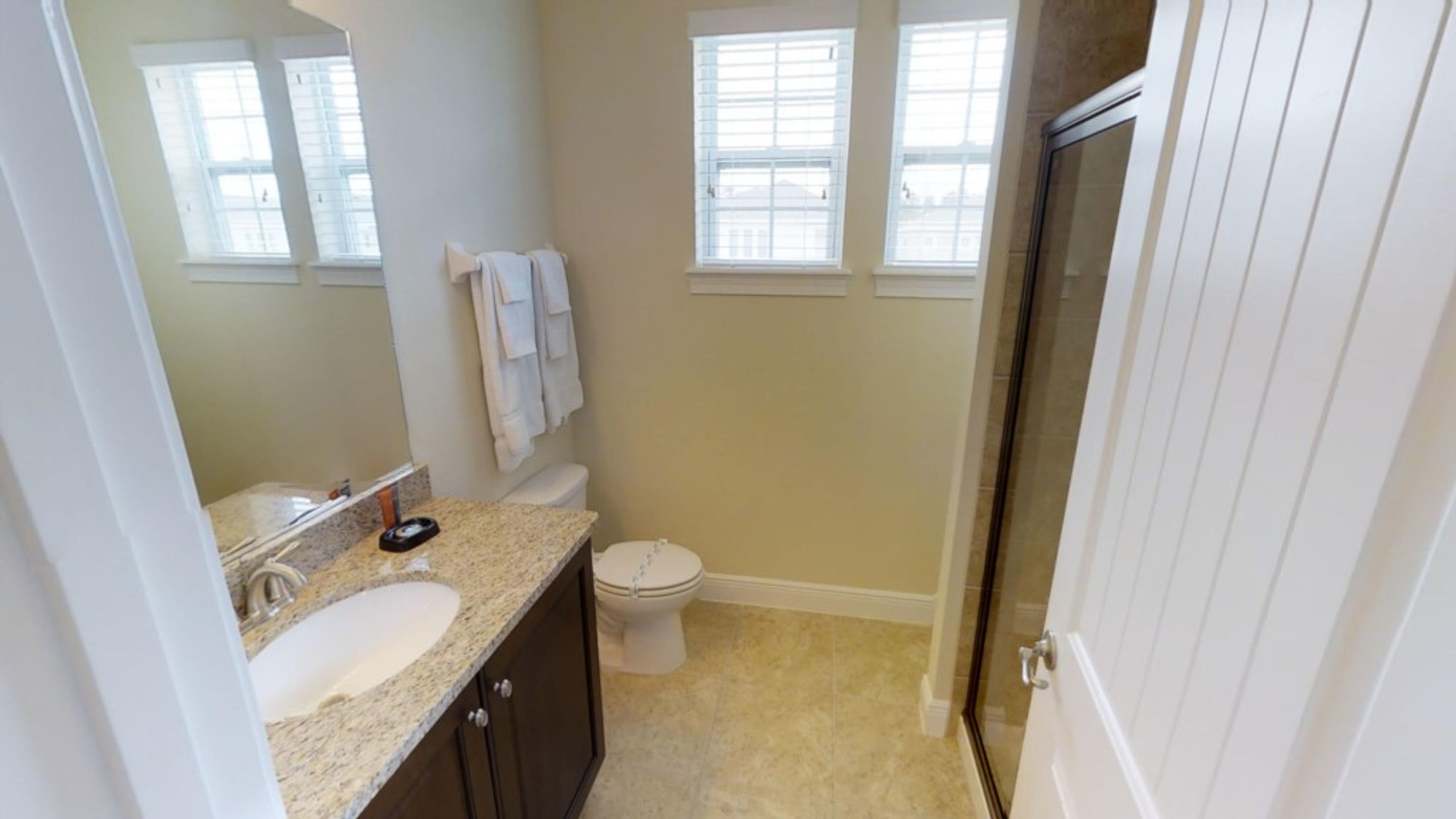 A bathroom with a sink, toilet, and shower.