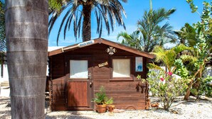 A wooden beach house with a door, windows, and a sign that reads "Beach House". - Noord 2 (Noord)